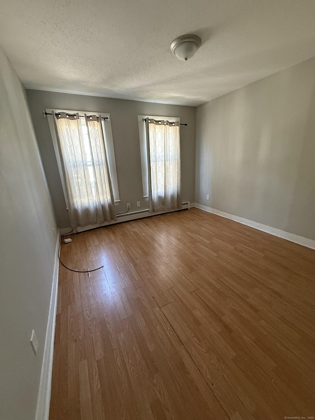 14 Market St, New Haven, CT 06513 - empty room with wood finished floors and a textured ceiling