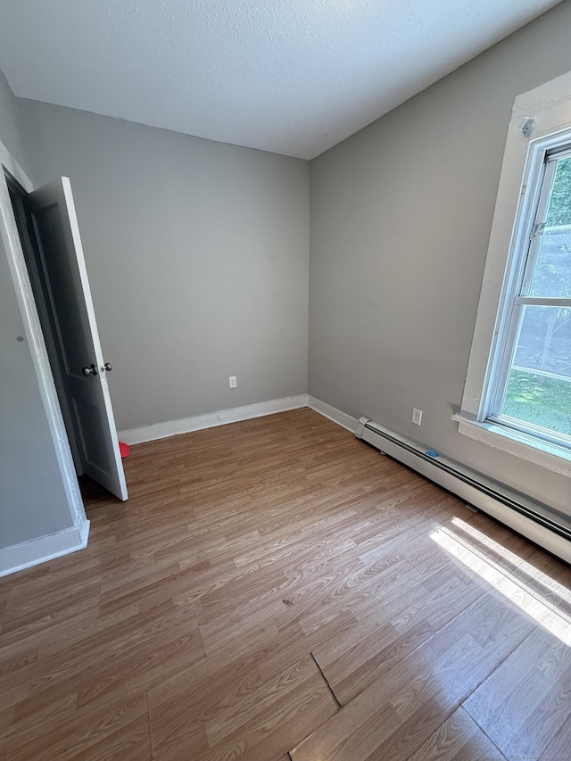 14 Market St, New Haven, CT 06513 - empty room with wood finished floors and a baseboard radiator
