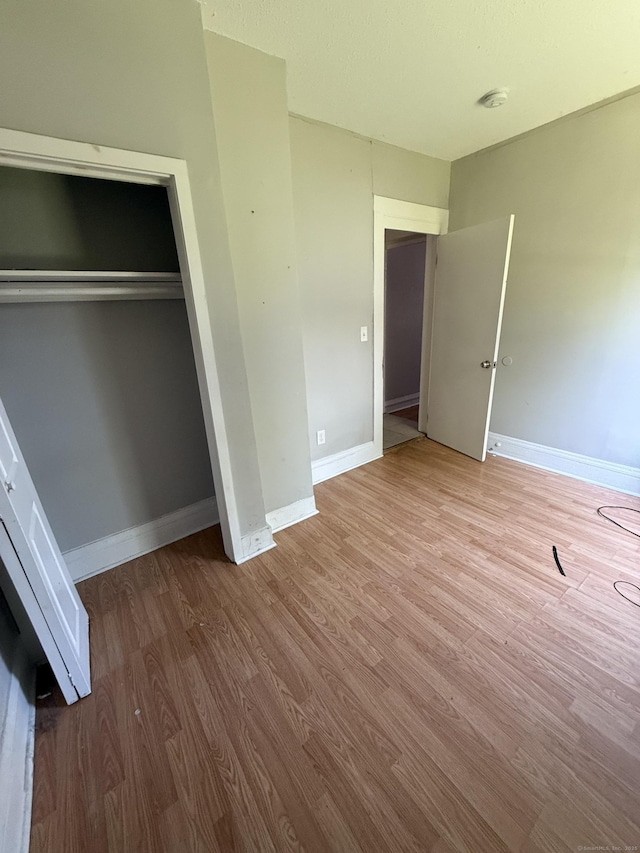 14 Market St, New Haven, CT 06513 - unfurnished bedroom featuring wood finished floors and a closet