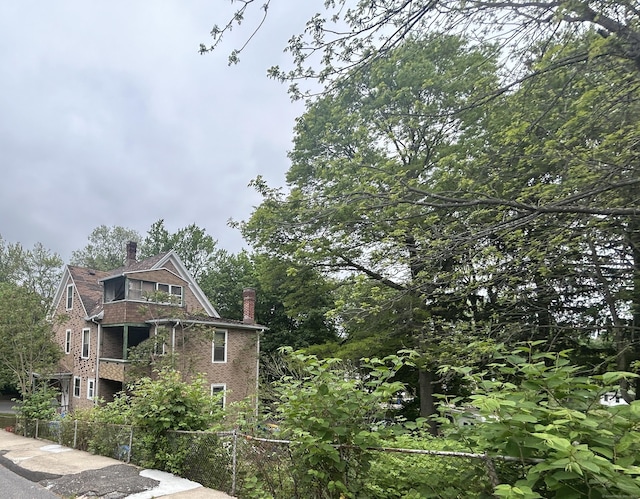 578 Columbia Boulevard Extension, Waterbury, CT 06704 - view of home's exterior featuring brick siding and a chimney