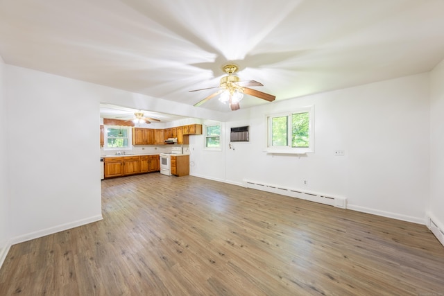 510 Sylvan Lake Rd, Watertown, CT 06779 - unfurnished living room featuring a baseboard radiator, plenty of natural light, wood finished floors, and ceiling fan
