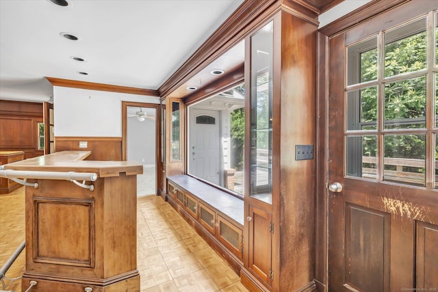 5550 Main St, Stratford, CT 06614 - interior space featuring plenty of natural light, a wainscoted wall, crown molding, light countertops, and wood walls