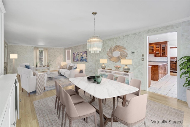 5550 Main St, Stratford, CT 06614 - dining space with wallpapered walls, light wood-style floors, a chandelier, and crown molding