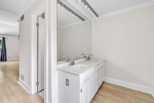 5550 Main St, Stratford, CT 06614 - bathroom with wood finished floors, double vanity, and crown molding
