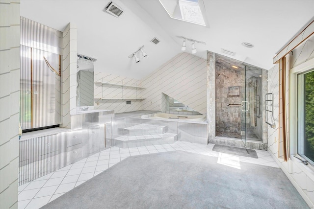 5550 Main St, Stratford, CT 06614 - bathroom featuring track lighting, a shower stall, a bath, tile patterned floors, and vaulted ceiling