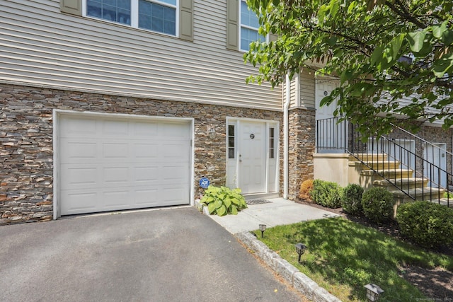 27 Riverview Ct Unit 27, Brookfield, CT 06804 - property entrance featuring stone siding and a garage