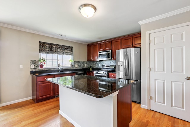 27 Riverview Ct Unit 27, Brookfield, CT 06804 - kitchen with appliances with stainless steel finishes, tasteful backsplash, light wood-style floors, ornamental molding, and a kitchen island