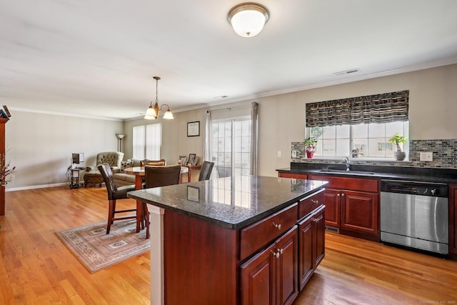 27 Riverview Ct Unit 27, Brookfield, CT 06804 - kitchen with stainless steel dishwasher, reddish brown cabinets, light wood-style floors, open floor plan, and a center island