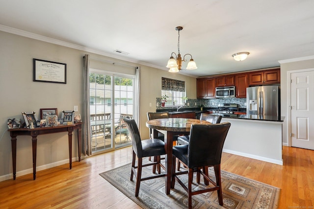 27 Riverview Ct Unit 27, Brookfield, CT 06804 - dining space featuring a chandelier, ornamental molding, and light wood finished floors