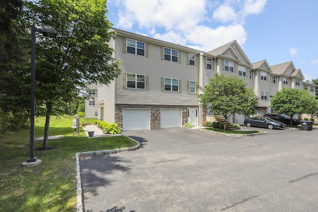 27 Riverview Ct Unit 27, Brookfield, CT 06804 - view of front facade with stone siding, a garage, asphalt driveway, a residential view, and a front yard
