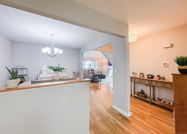 76 Highland Dr Unit 76, Monroe, CT 06468 - kitchen featuring light wood-style flooring, a chandelier, and pendant lighting