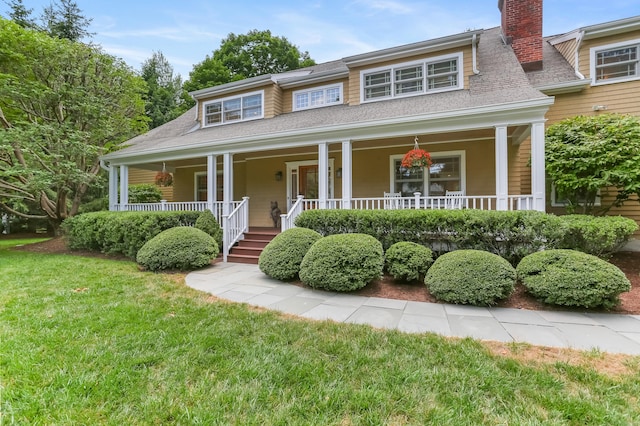 4 Reimer Rd, Westport, CT 06880 - view of front facade with a chimney, covered porch, a front lawn, and a shingled roof