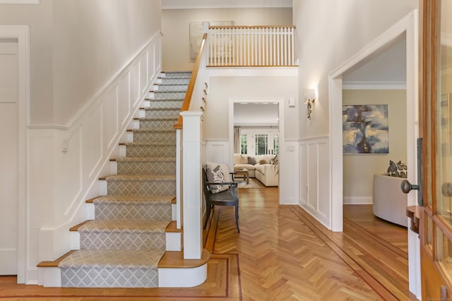 4 Reimer Rd, Westport, CT 06880 - staircase with a decorative wall, crown molding, and a wainscoted wall