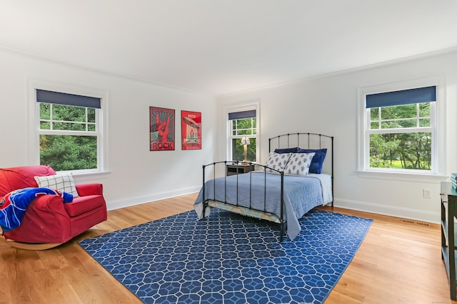 4 Reimer Rd, Westport, CT 06880 - bedroom with multiple windows, crown molding, and light wood-type flooring