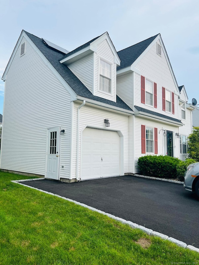 48 Harris Dr, Newington, CT 06111 - view of front of property with a shingled roof, a front yard, asphalt driveway, and a garage