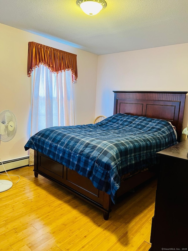 48 Harris Dr, Newington, CT 06111 - bedroom featuring a baseboard radiator and light wood-style floors