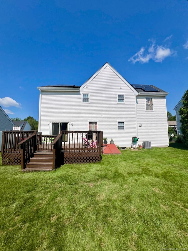48 Harris Dr, Newington, CT 06111 - rear view of property featuring a wooden deck and a lawn