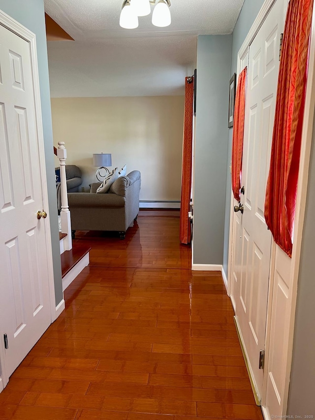 48 Harris Dr, Newington, CT 06111 - corridor with baseboard heating and wood finished floors