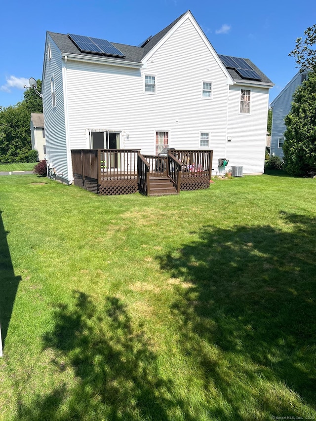 48 Harris Dr, Newington, CT 06111 - back of house featuring roof mounted solar panels, a lawn, and a wooden deck