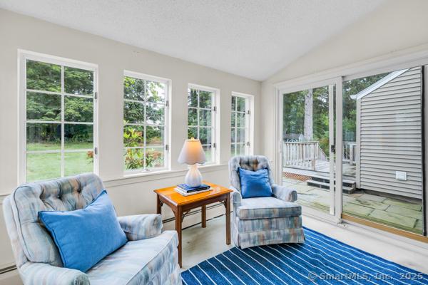 588 Fern St, West Hartford, CT 06107 - sunroom / solarium featuring healthy amount of natural light, vaulted ceiling, and a baseboard heating unit