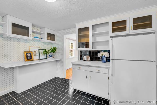 588 Fern St, West Hartford, CT 06107 - kitchen featuring freestanding refrigerator, open shelves, wallpapered walls, a textured ceiling, and light countertops