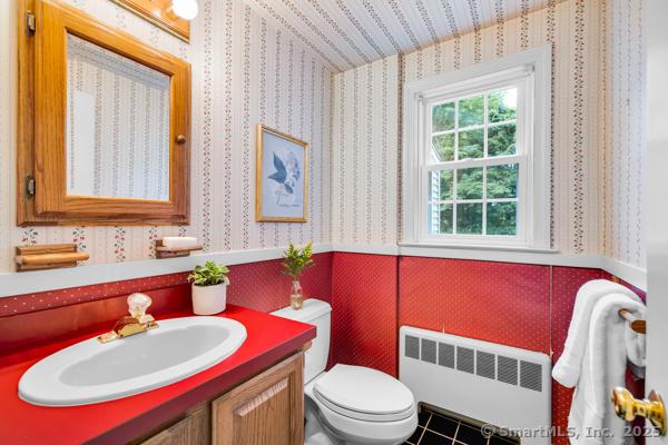 588 Fern St, West Hartford, CT 06107 - bathroom featuring radiator heating unit, vanity, wallpapered walls, and tile patterned flooring