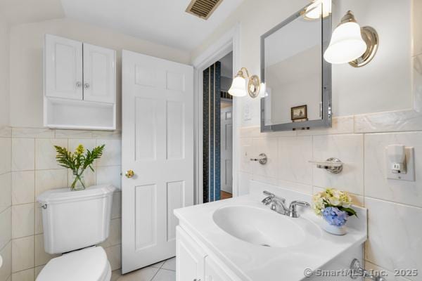 588 Fern St, West Hartford, CT 06107 - half bath with tile walls, vanity, and tile patterned floors