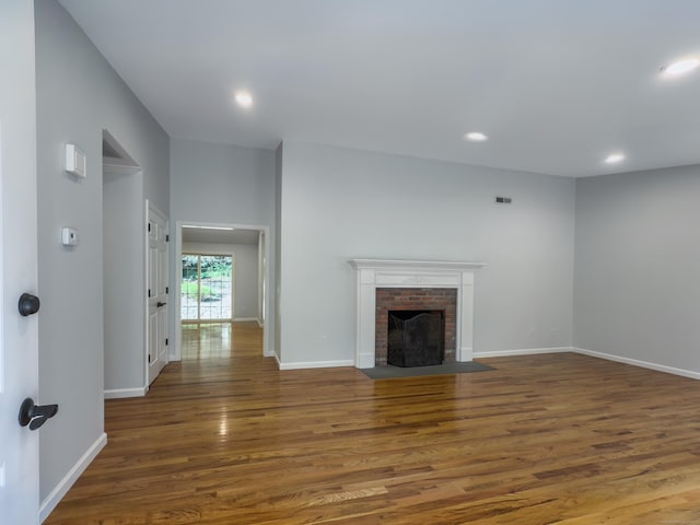 6 Jeffro Dr, Ridgefield, CT 06877 - unfurnished living room featuring wood finished floors, recessed lighting, and a brick fireplace