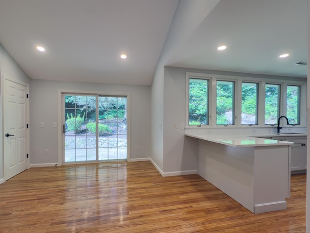 6 Jeffro Dr, Ridgefield, CT 06877 - kitchen featuring lofted ceiling, light wood-style flooring, light countertops, recessed lighting, and white cabinets