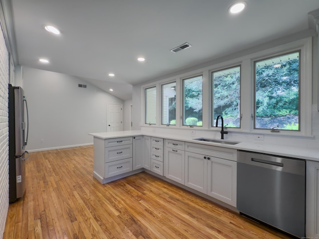 6 Jeffro Dr, Ridgefield, CT 06877 - kitchen with stainless steel appliances, light countertops, a peninsula, light wood-style flooring, and recessed lighting