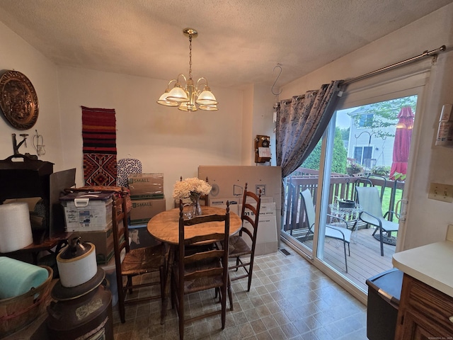 16 Seymour Rd Unit 2C, East Granby, CT 06026 - dining room with a chandelier, a textured ceiling, and tile patterned floors