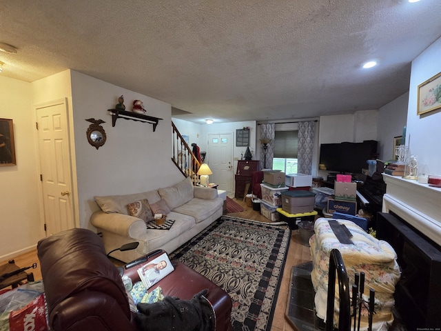 16 Seymour Rd Unit 2C, East Granby, CT 06026 - living area featuring stairs, a textured ceiling, wood finished floors, and recessed lighting