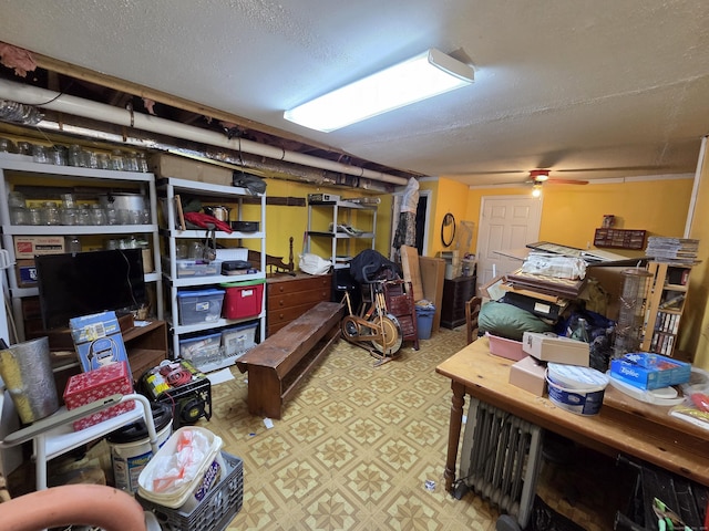 16 Seymour Rd Unit 2C, East Granby, CT 06026 - basement with tile patterned floors, a ceiling fan, and a textured ceiling