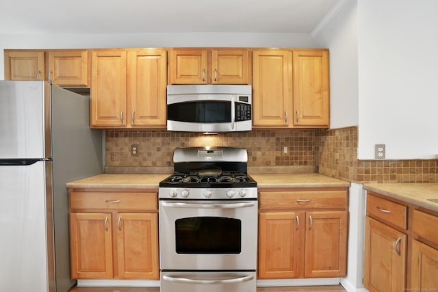 1802 Pinnacle Way Unit 1802, Danbury, CT 06811 - kitchen with appliances with stainless steel finishes, light countertops, decorative backsplash, and ornamental molding