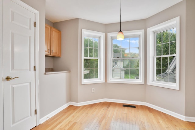 1802 Pinnacle Way Unit 1802, Danbury, CT 06811 - unfurnished dining area with light wood-style flooring and healthy amount of natural light