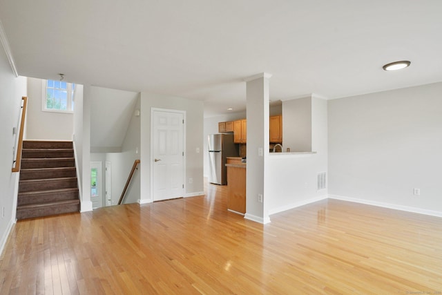 1802 Pinnacle Way Unit 1802, Danbury, CT 06811 - unfurnished living room with light wood-style flooring and stairway