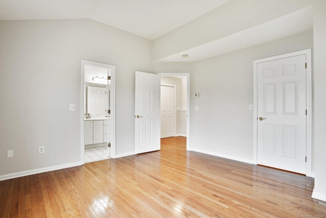 1802 Pinnacle Way Unit 1802, Danbury, CT 06811 - unfurnished bedroom featuring light wood finished floors, vaulted ceiling, and ensuite bathroom