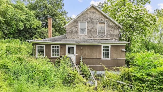 212 Prospect St, Norwich, CT 06360 - view of front of property with a chimney and a shingled roof