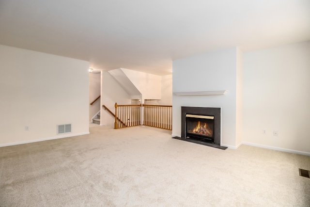 2303 Eaton Ct Unit 2303, Danbury, CT 06811 - unfurnished living room featuring carpet flooring, a fireplace with flush hearth, and stairway