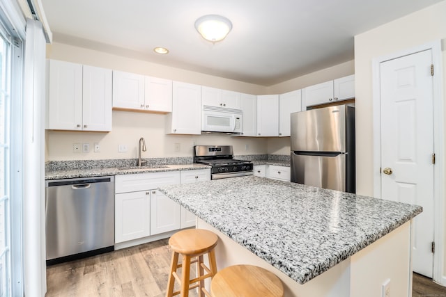 2303 Eaton Ct Unit 2303, Danbury, CT 06811 - kitchen featuring stainless steel appliances, light wood-style flooring, white cabinets, and recessed lighting