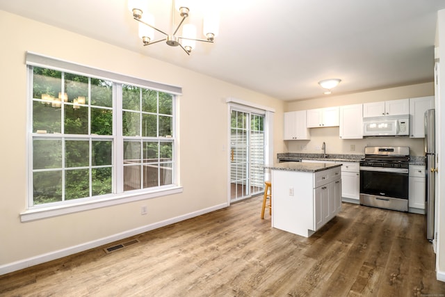 2303 Eaton Ct Unit 2303, Danbury, CT 06811 - kitchen featuring appliances with stainless steel finishes, a chandelier, white cabinets, and dark wood-type flooring