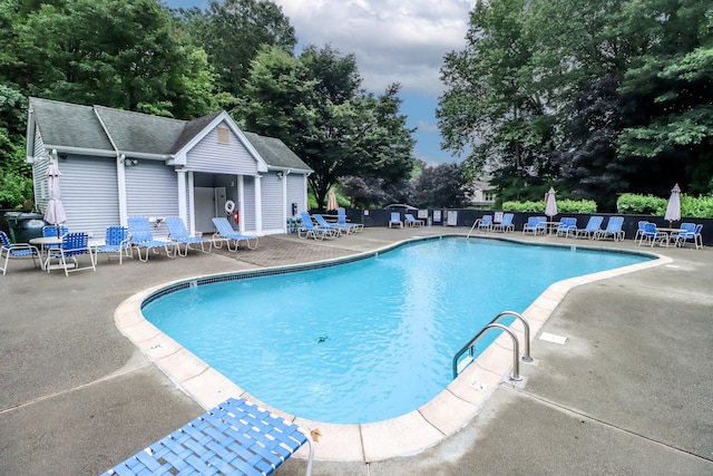2303 Eaton Ct Unit 2303, Danbury, CT 06811 - community pool featuring a patio area, view of wooded area, and an outdoor structure
