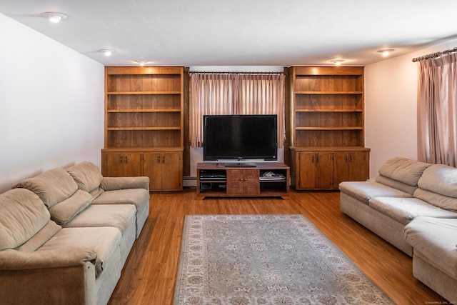 56 Franklin St, Vernon, CT 06066 - living room featuring a baseboard heating unit and wood finished floors
