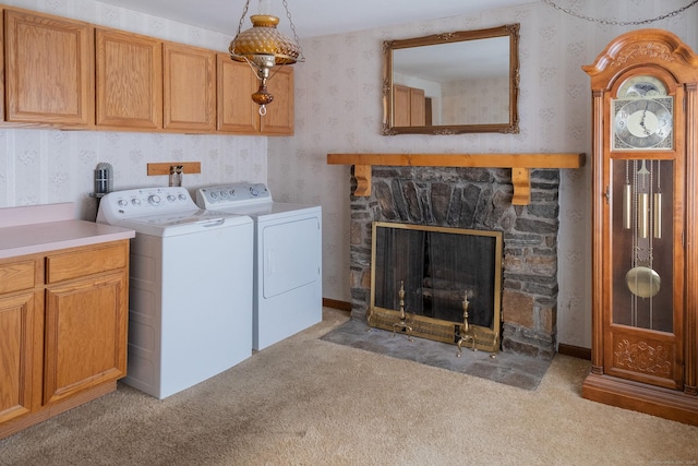 56 Franklin St, Vernon, CT 06066 - laundry area featuring washer and dryer, cabinet space, wallpapered walls, light carpet, and a stone fireplace