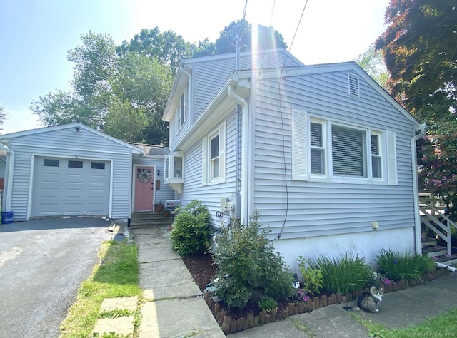 50 Howe St, Milford, CT 06460 - view of front of home featuring an attached garage and driveway