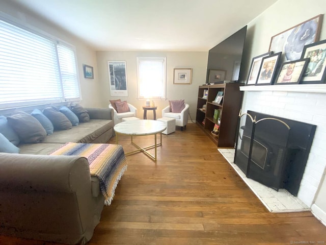 50 Howe St, Milford, CT 06460 - living area featuring wood finished floors, healthy amount of natural light, and a brick fireplace