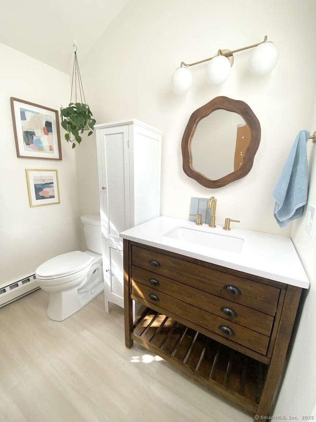 50 Howe St, Milford, CT 06460 - half bath with baseboard heating, vanity, and wood finished floors