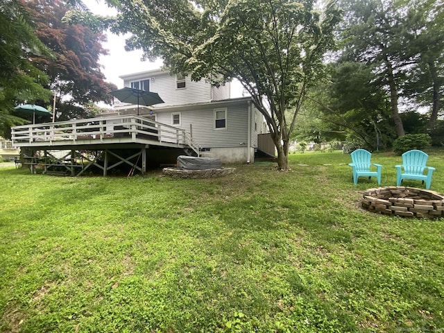 50 Howe St, Milford, CT 06460 - view of grassy yard with a fire pit and a wooden deck