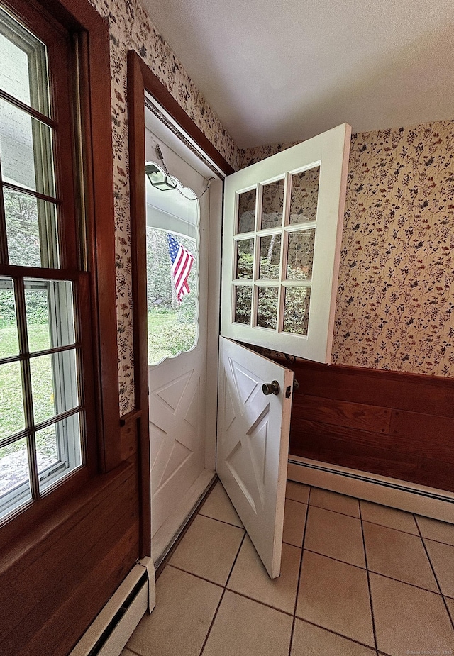 364 Locust Rd, Harwinton, CT 06791 - doorway to outside with wallpapered walls, a baseboard heating unit, baseboard heating, and light tile patterned floors
