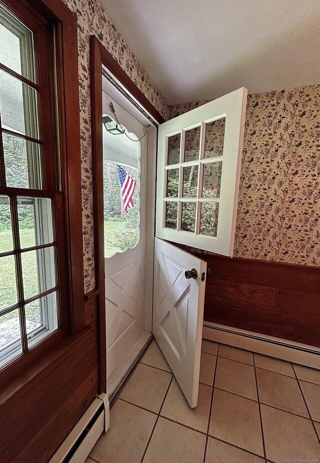 364 Locust Rd, Harwinton, CT 06791 - doorway to outside with wallpapered walls, a baseboard heating unit, baseboard heating, and light tile patterned floors